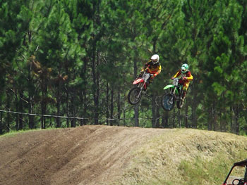 FLMN - Johnny Wasco and Bo Partin side-by-side over motocross jump